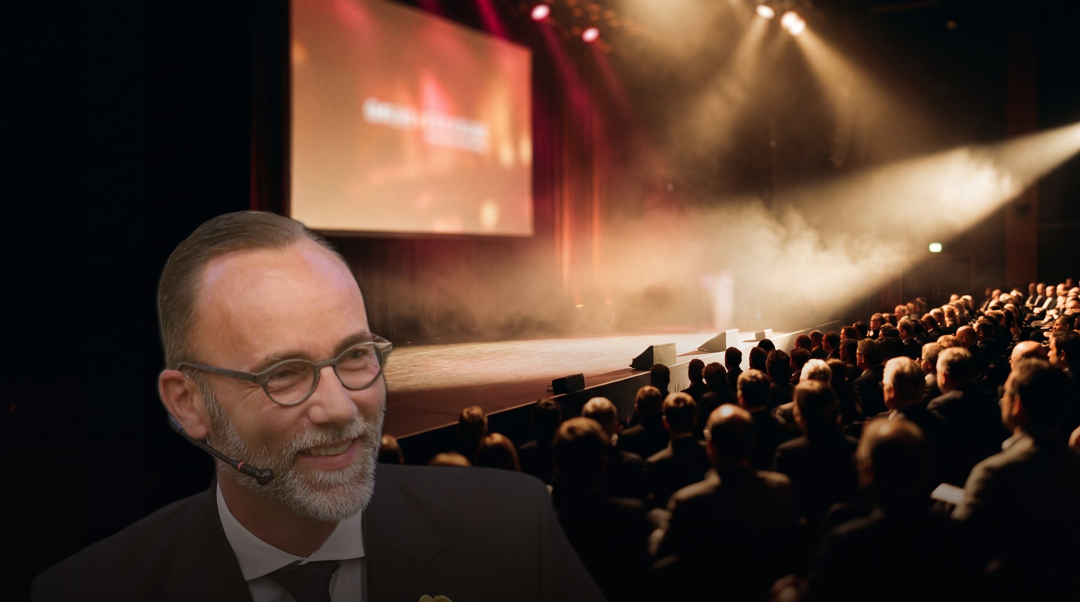 Jan Schaumann hält einen Vortrag auf einer großen Bühne vor Publikum